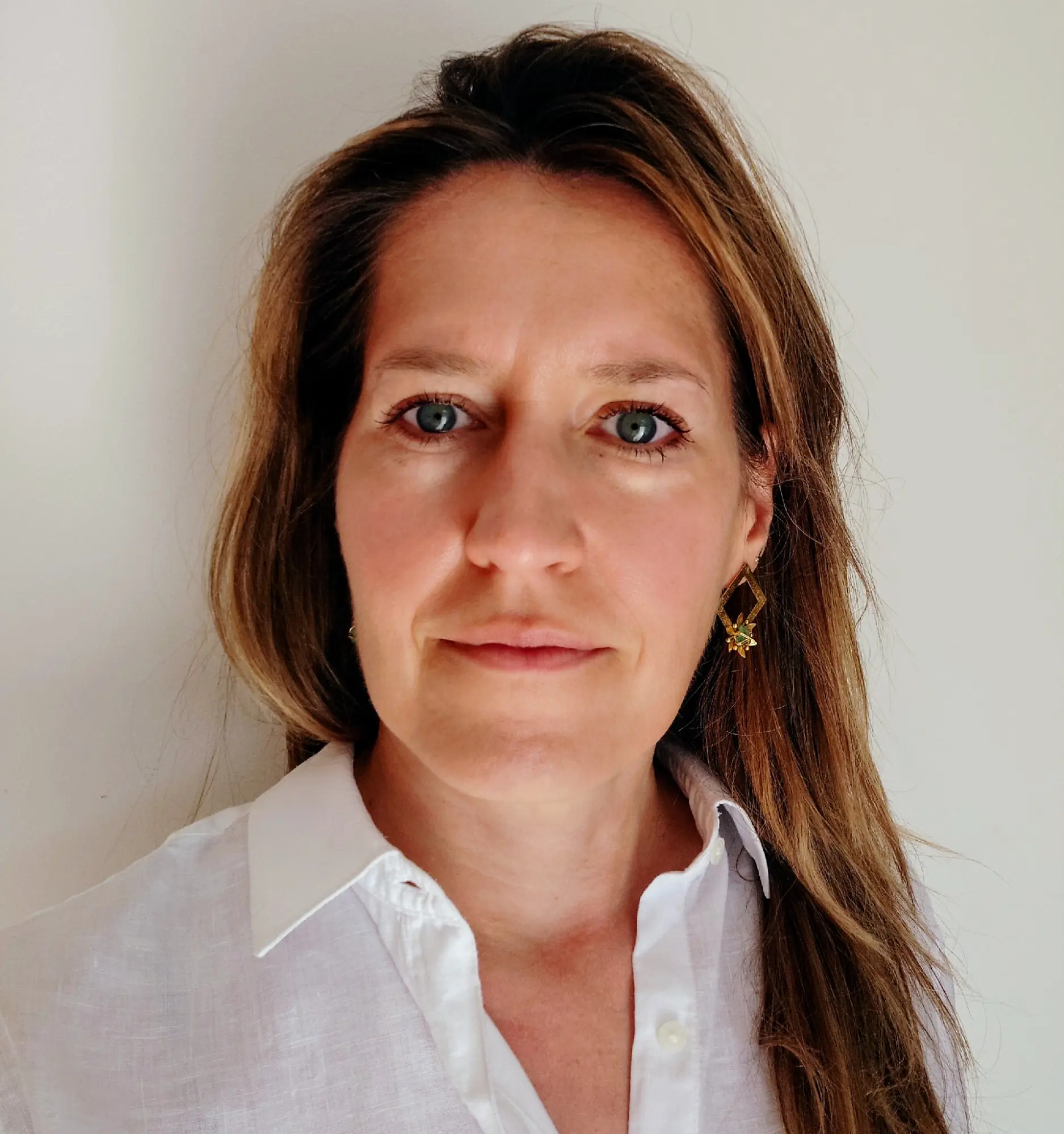 Professional headshot of Catherine Kielar wearing a white collared shirt against a neutral background.