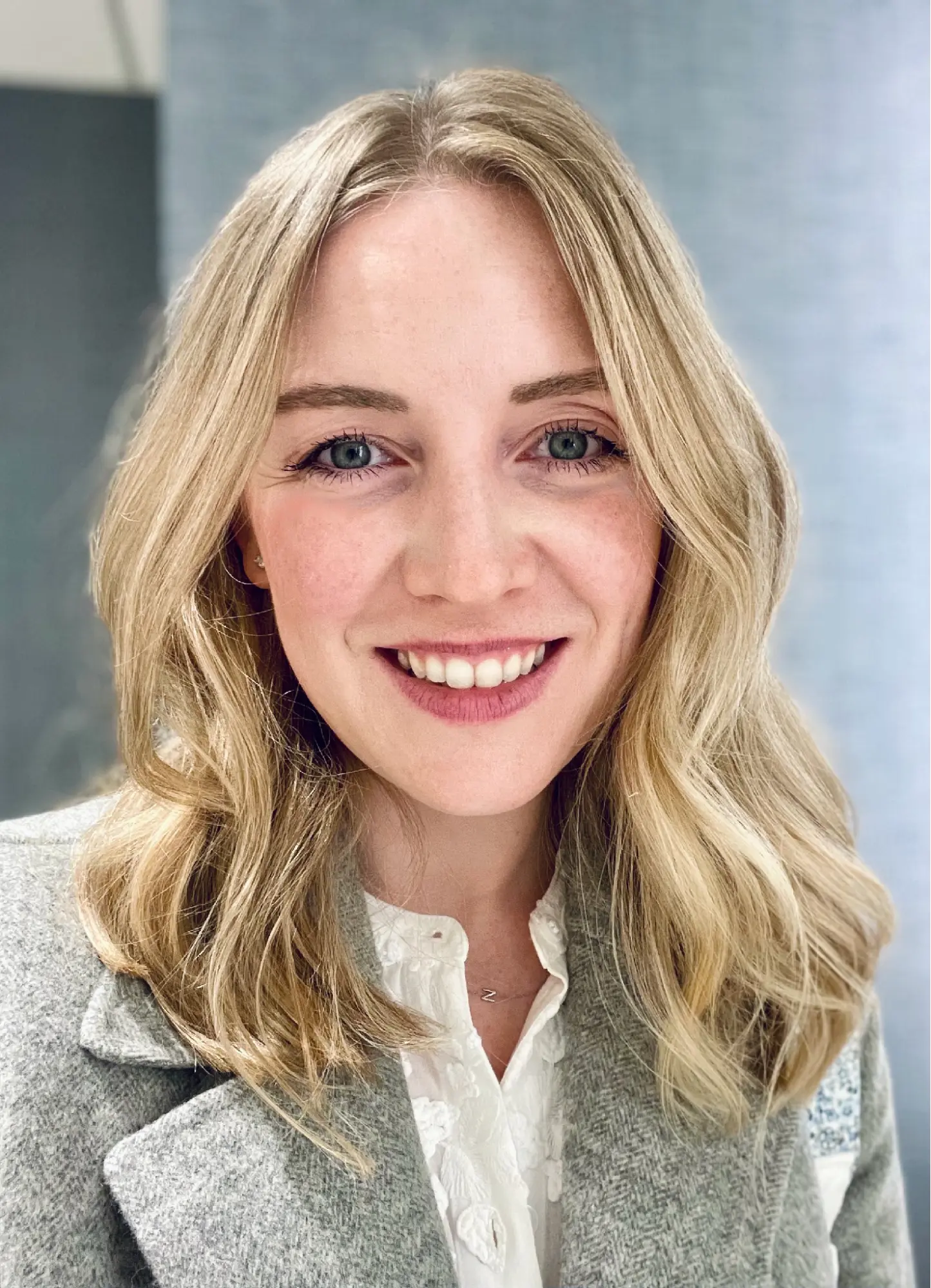 Diana Amari smiling in a professional headshot wearing a grey blazer.