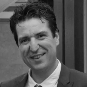 Michael Livingstone, Chief People Officer at Genesis Research Group, smiling in a professional headshot.