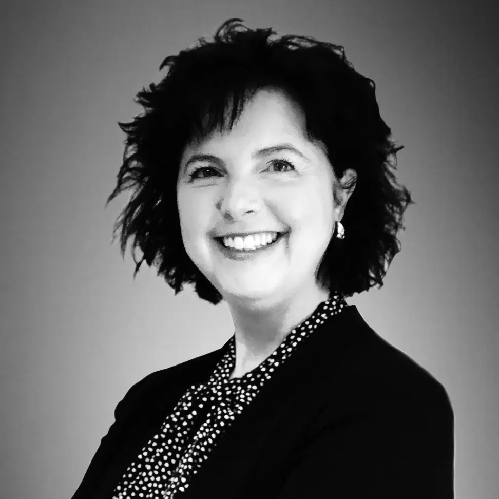 Professional black and white headshot of Nikki Atkins, Vice President of Access and Commercialization